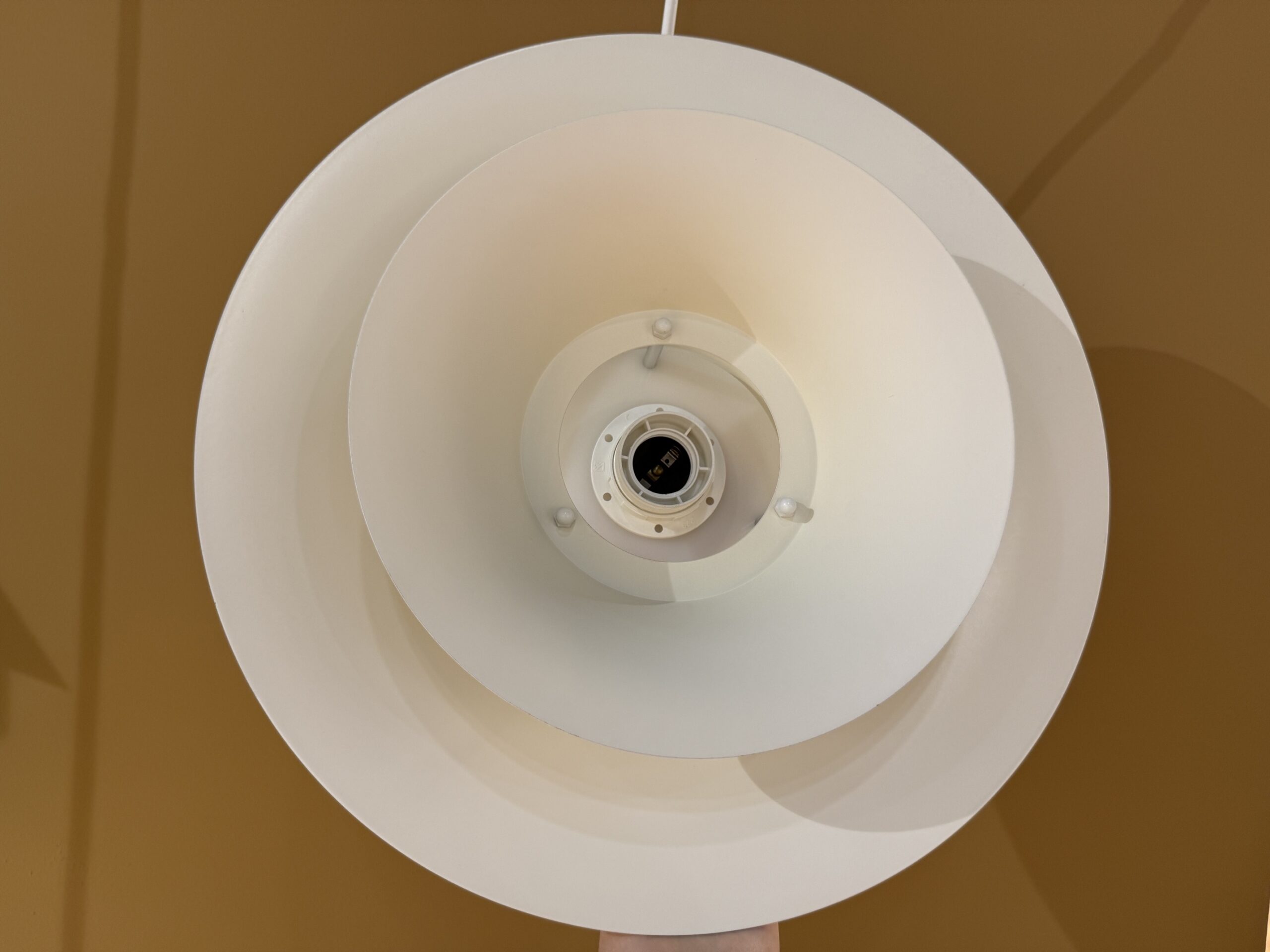 Vintage Scandinavian pendant lamp in cream color with layered design and atmospheric light distribution